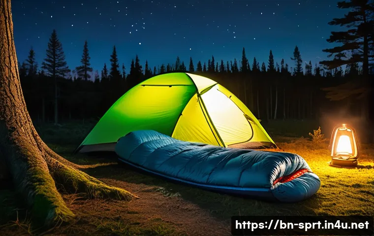 비박 야외 취침  필수 장비 - A cozy outdoor camping scene at night featuring a lightweight sleeping bag designed for cold weather...