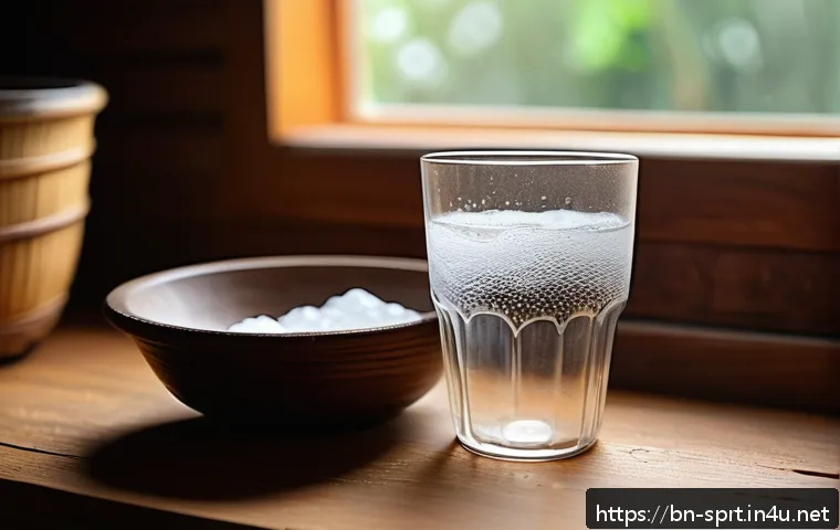 스포츠 텀블러 세척 팁 - A detailed close-up of a transparent tumbler filled halfway with warm water mixed with baking soda, ...