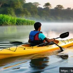 초보자를 위한 카약 패들 길이 - A detailed scene of a Bengali kayaker paddling on a calm lake during early morning, wearing a life j...